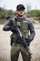 Army soldier shooting with rifle machine gun in the forest
