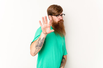 Young caucasian red-haired man isolated on white background rejecting someone showing a gesture of...