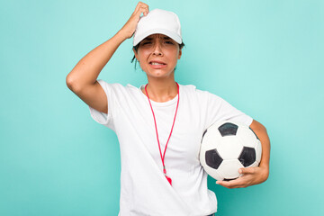 Young hispanic soccer referee woman isolated on blue background being shocked, she has remembered...