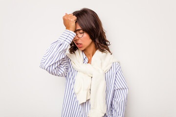 Young hispanic woman isolated on white background forgetting something, slapping forehead with palm...