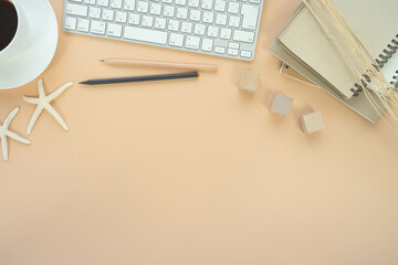 Flat lay of top view desk work table with Coffee computer notebook and pencil work space in minimal orange color autumn tone concept includes copyspace for add text or graphic