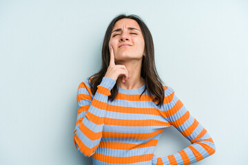 Young caucasian woman isolated on blue background crying, unhappy with something, agony and confusion concept.