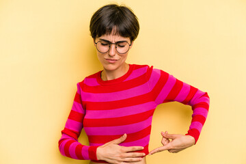 Young caucasian woman with a short hair cut isolated having a liver pain, stomach ache.
