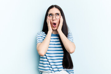 Young caucasian woman isolated on blue background whining and crying disconsolately.