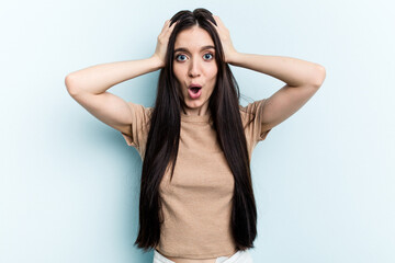 Fototapeta premium Young caucasian woman isolated on blue background being shocked, she has remembered important meeting.