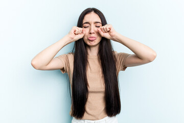 Young caucasian woman isolated on blue background whining and crying disconsolately.