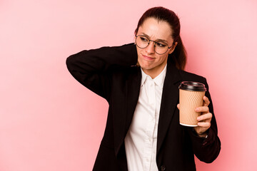 Young business caucasian woman holding take away coffee isolated on pink background touching back...