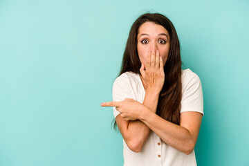 Fototapeta premium Young caucasian woman isolated on blue background pointing to the side