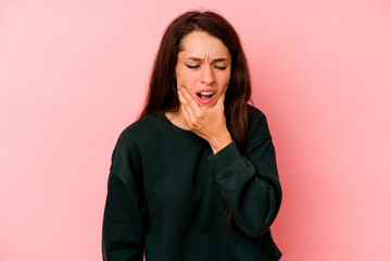 Young caucasian woman isolated on pink background having a strong teeth pain, molar ache.