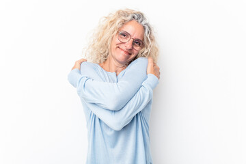 Middle age caucasian woman isolated on white background hugs, smiling carefree and happy.
