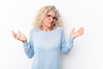 Middle age caucasian woman isolated on white background doubting and shrugging shoulders in...