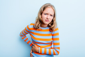 Caucasian teen girl isolated on blue background having a liver pain, stomach ache.