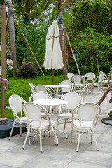 White table and chair arrangement and chandelier for outdoor tent party