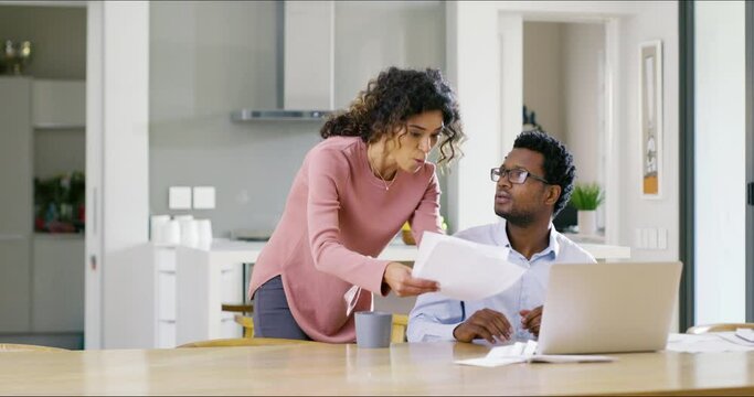 Angry, upset and frustrated wife shouting and arguing with her husband over finance, budget and debt at home. Stress, anxiety and anger over savings, financial investment and household money problems