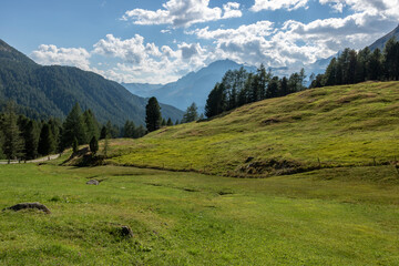 Swiss mountains and lakes on a sunny day with white clouds