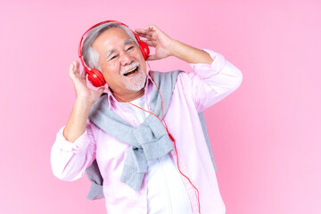 senior old man smile wearing red headphones, happiness asian old man listen music dance pink...