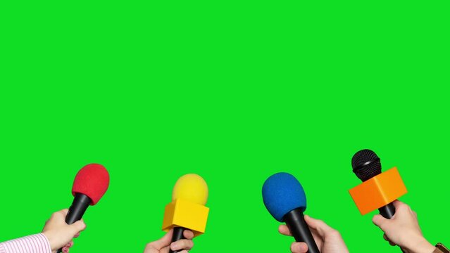 Microphones in the hands of journalists for interview on green screen background. Conference meeting microphones prepared for talker isolated on chroma key background