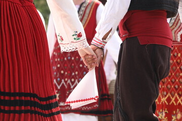 People in traditional folk costume of The National Folklore Fair in Koprivshtica. The National Folklore Fair in Koprivshtica is entered in the UNESCO Register of the human intangible cultural heritage - obrazy, fototapety, plakaty