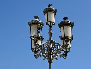 Fototapeta na wymiar Historic metal lantern in front of blue sky