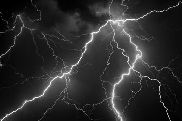 Fork lightning striking down during summer storm in black and white