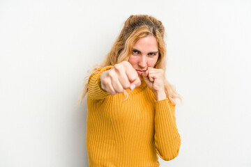 Obraz premium Young caucasian woman isolated on white background throwing a punch, anger, fighting due to an argument, boxing.