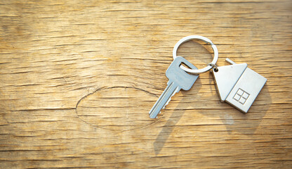 House keys on wooden background.