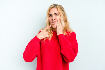 Young caucasian woman isolated on blue background having a strong teeth pain, molar ache.