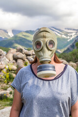 Portrait of a woman in a gas mask in nature close-up