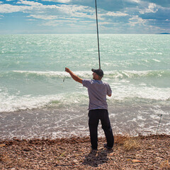fisherman fishing on the ocean with a rod and bait for big fish