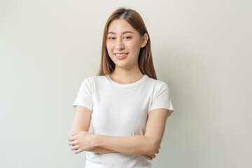 Smile positive, attractive asian young woman wearing casual, portrait of beautiful brunette her with long hair, feeling happy looking at camera, standing cross arms chest isolated on white background.