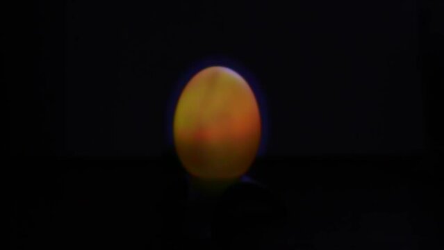 the egg-shaped lantern changes different colors in the dark. Creative. World Egg Day