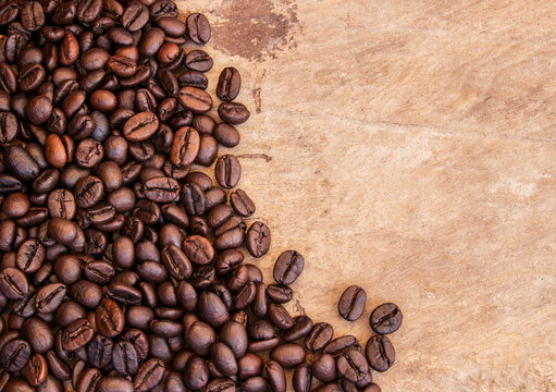 Coffee beans on grunge wooden background © Flaviu
