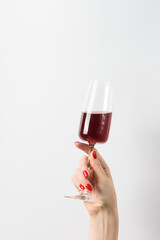 female hand with red wine on white background