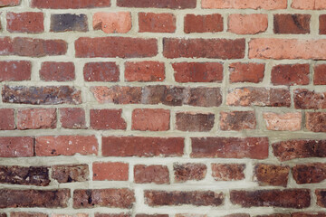 Brick wall background. Pattern brown color design decorative uneven cracked real stone wall surface with cement. Dry brick wall as seamless background