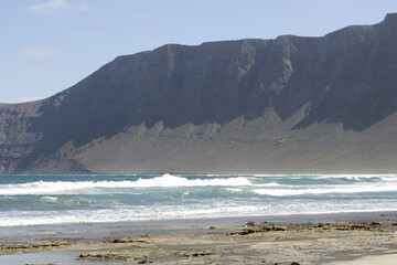 Fototapeta na wymiar Famara Beach, surfing beach in Lanzarote, Canary Islands, Spain