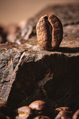 Roasted coffee beans on stone pedestal brown background