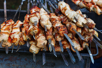 The meat is cooked on the grill. The process of cooking barbecue on coals.