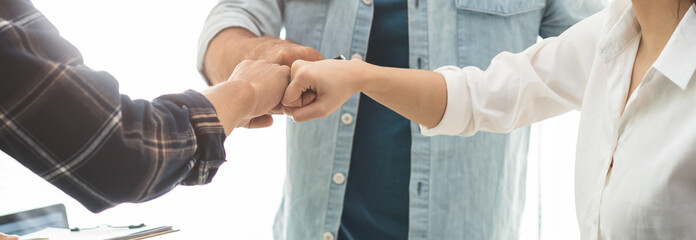 Business team standing hands together showing teamwork and trust © Pormezz
