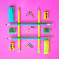 Neatly arranged pattern made of wooden pencils on pink background with school supplies. Creative...