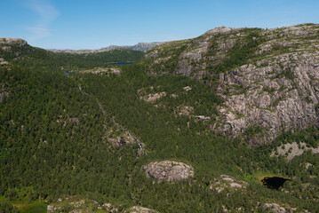 Fototapeta na wymiar The rough rocky mountain landscape on the way to Pulpit Rock (Preikestolen), Stavanger, Norway