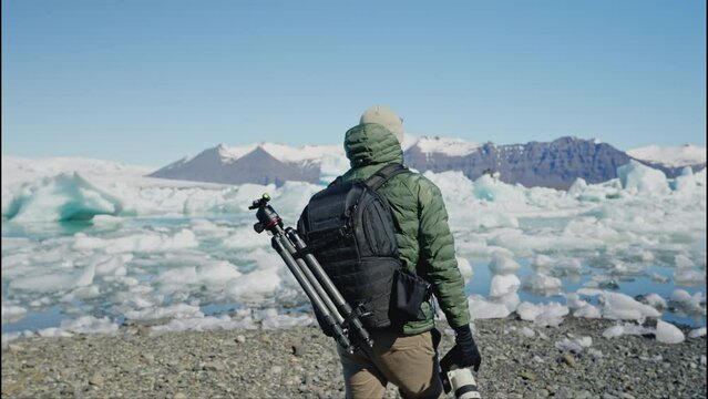 Man Photographer with Backpack Walks Towards Jokulsarlon Glacier Lagoon Iceland