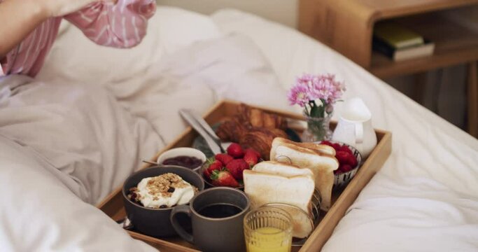 Social media influencer taking photo on phone of healthy breakfast in bed. Online nutritionist sharing a healthy, tasty and balanced meal with her internet followers, promoting vegan health benefits