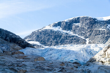 Part of the Nigardsbreen glacier surrounded by high snow capped mountains