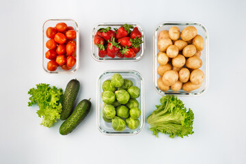Glass boxes with fresh raw vegetables.  Vegetables and fruits in glass containers. Food storage concept