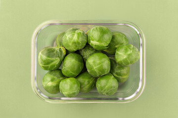 Glass box with fresh brussels sprouts.  Vegetables in a glass containers. Food storage concept