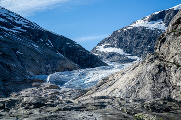 Fototapeta premium Part of the Nigardsbreen glacier surrounded by high snow capped mountains