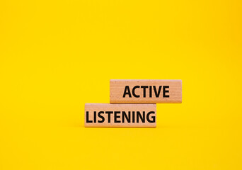 Active listening symbol. Wooden blocks with words Active listening. Beautiful yellow background. Business and Active listening concept. Copy space.