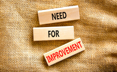 Need for improvement and support symbol. Concept words Need for improvement on wooden blocks on canvas. Beautiful canvas background. Business, need for improvement quote concept. Copy space.