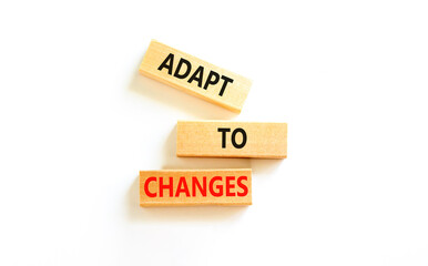 Adapt to changes symbol. Concept words Adapt to changes on wooden blocks. Beautiful white table...