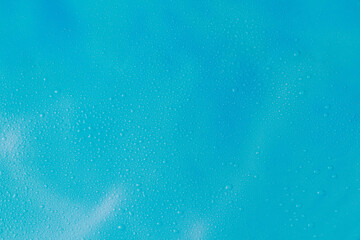 Empty blue background with water drops. Marine backdrop with copy space